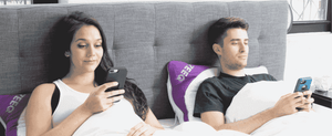 two people in bed on ZEEQ pillow using zeeq app
